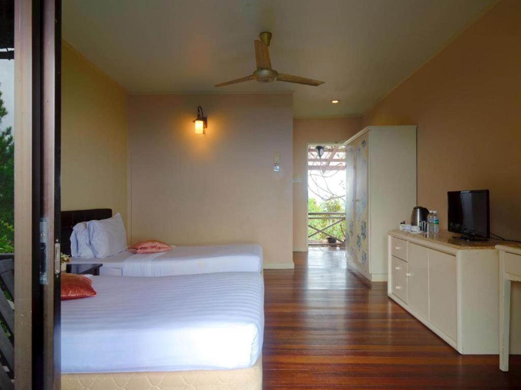 Postel nebo postele na pokoji v ubytování Kasih Sayang Hill Resort