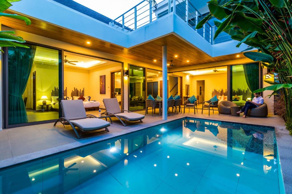 a villa with a swimming pool and a house at Ka villa private pool & maid by Lofty in Rawai Beach