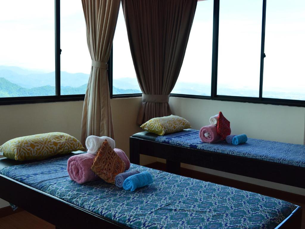 Postel nebo postele na pokoji v ubytování Kasih Sayang Hill Resort