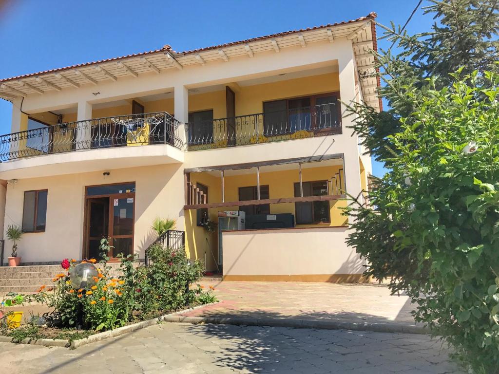 a house with a balcony in front of it at Complex Scorpion in 2 Mai