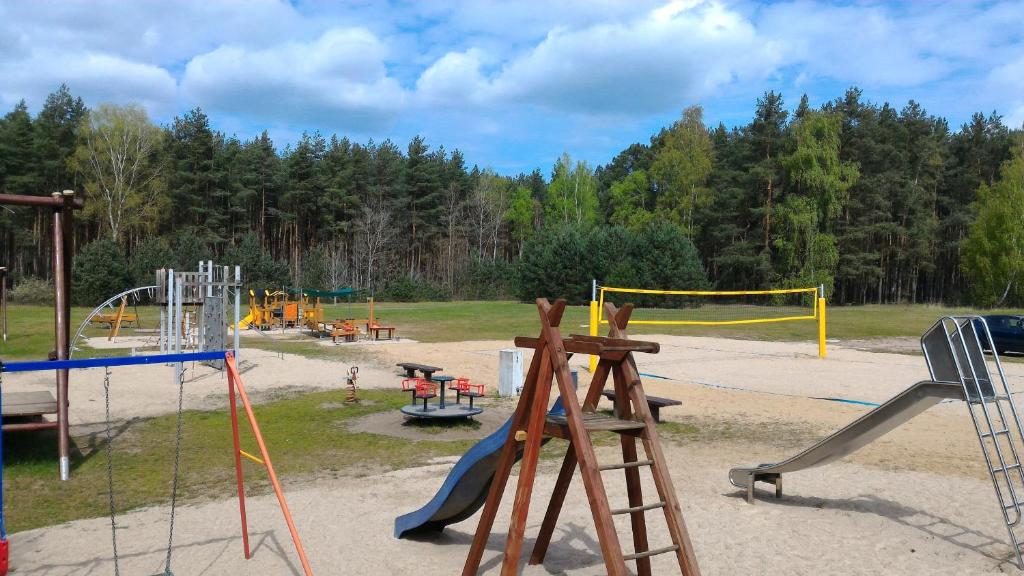 um parque infantil com um monte de escorregas e baloiços em La Porte em Bertingen