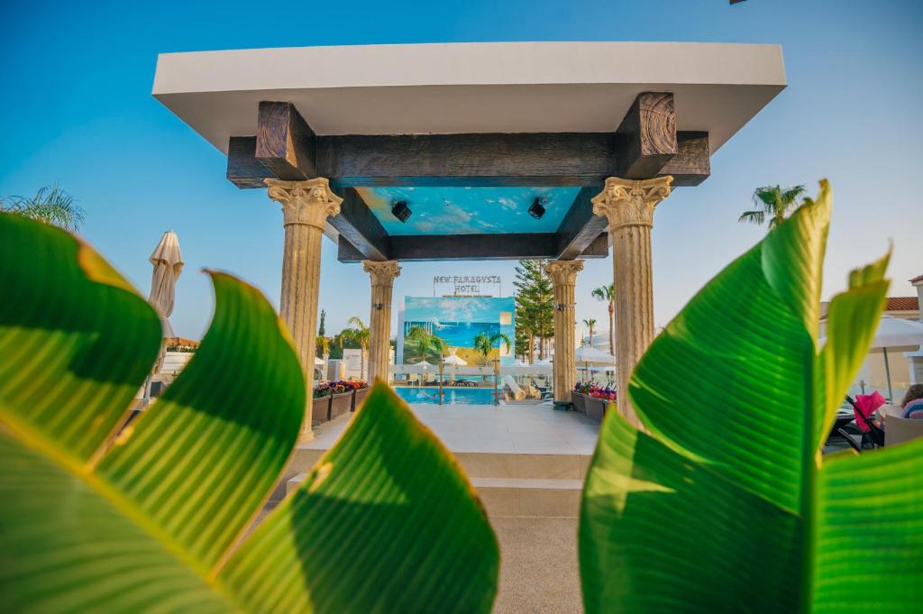a gazebo at a resort with green leaves at New Famagusta Hotel & Suites in Ayia Napa
