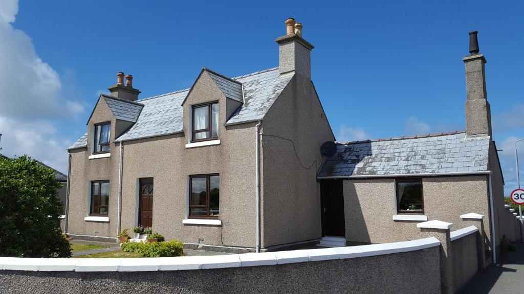 a large brick house with a roof at Taigh Na Casag in Lionel