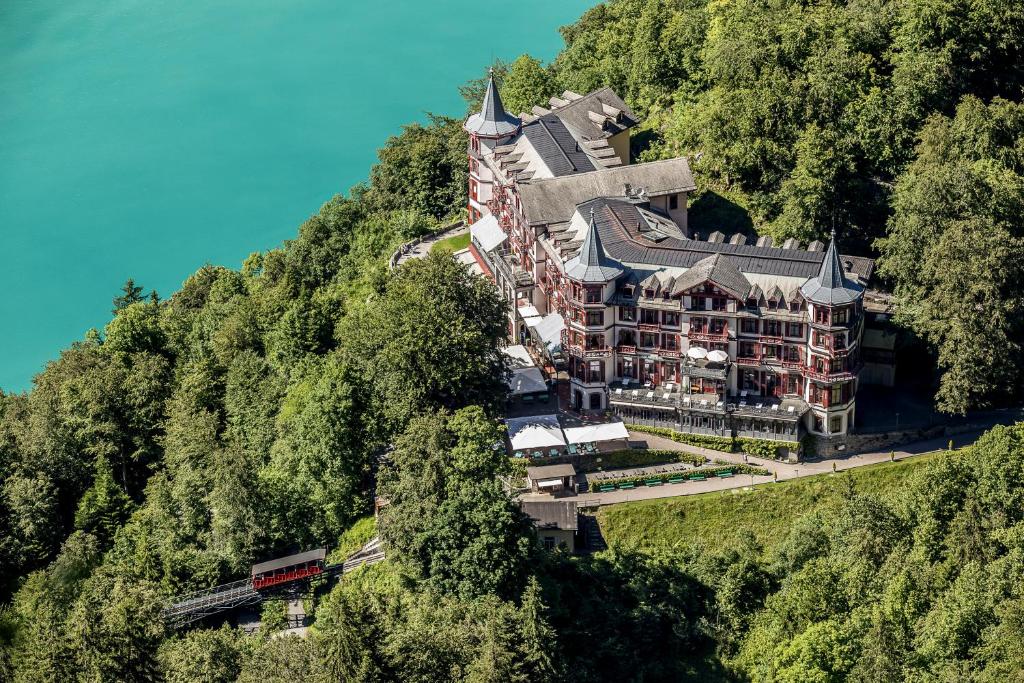 a building on the side of a mountain at Grandhotel Giessbach in Brienz
