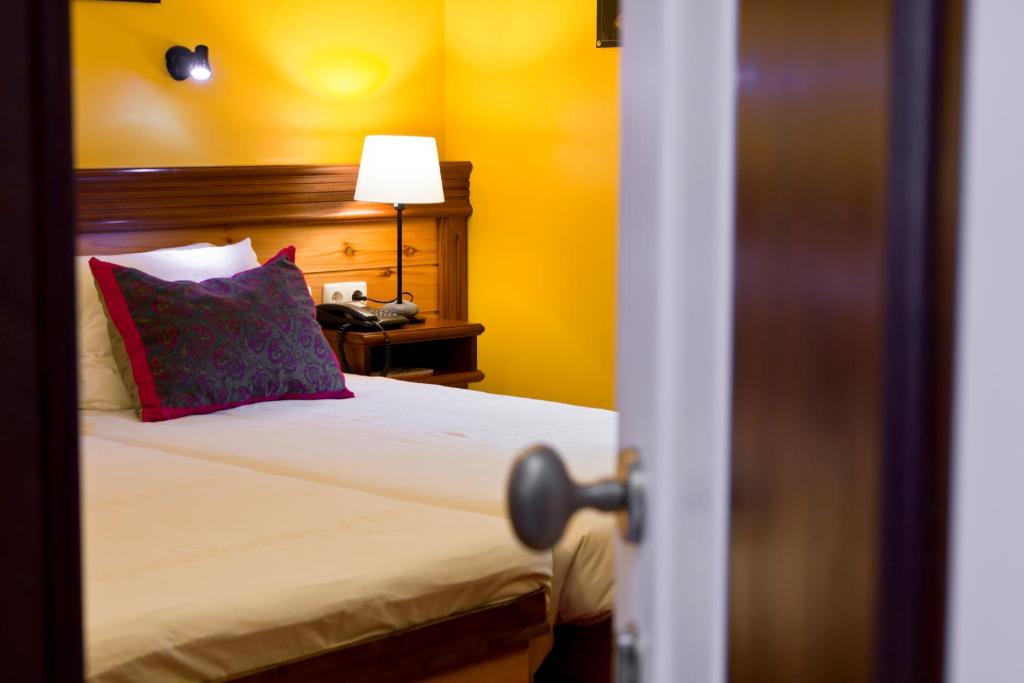 Postel nebo postele na pokoji v ubytování Aldeia da Fonte Hotel