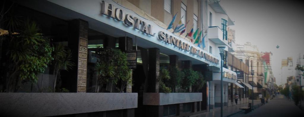 a building with a sign on the side of it at Hostal Santa Fe De La Veracruz in Santa Fe