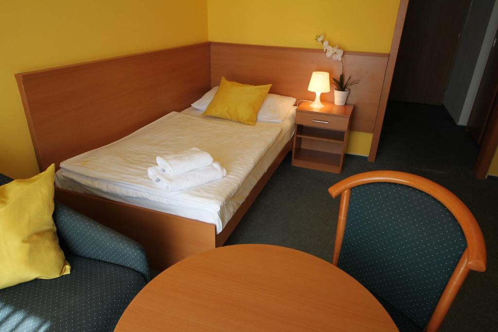 Postel nebo postele na pokoji v ubytování Hotel Meritum