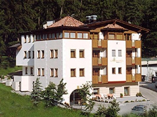 un grand bâtiment blanc au sommet d'une colline dans l'établissement Hotel Laerchenhain, à St. Valentin auf der Haide