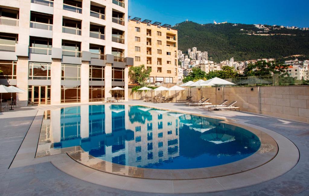 a large swimming pool in the middle of a building at The Rooms Boutique Hotel in Jounieh