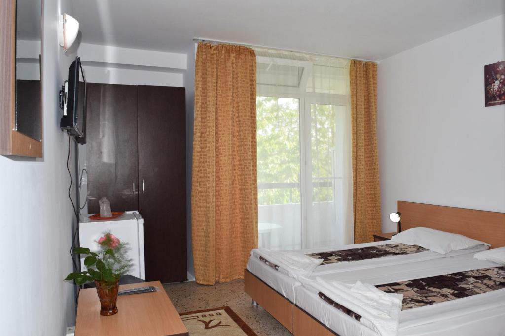 Postel nebo postele na pokoji v ubytování Hotel Sanda