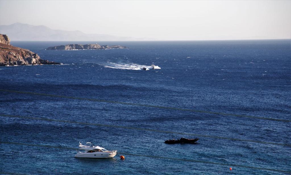 a boat in the middle of a large body of water at Mykonos Moussa in Agios Ioannis Mykonos