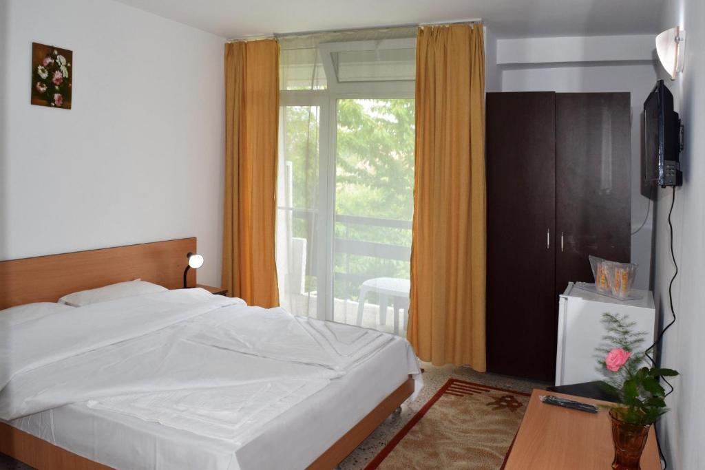 Postel nebo postele na pokoji v ubytování Hotel Sanda