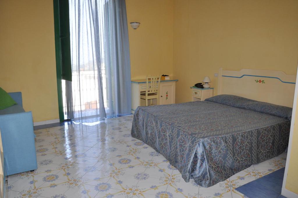 Postel nebo postele na pokoji v ubytování Hotel Savoia