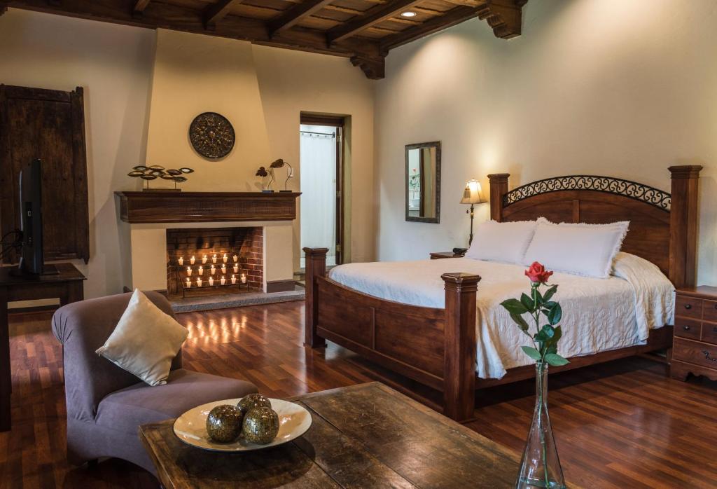 a bedroom with a bed and a fireplace at Casa Santa Rosa Hotel Boutique in Antigua Guatemala