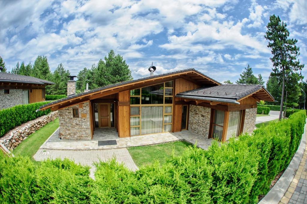 a house with a stone and wood at Golf Villa Malina in Bansko