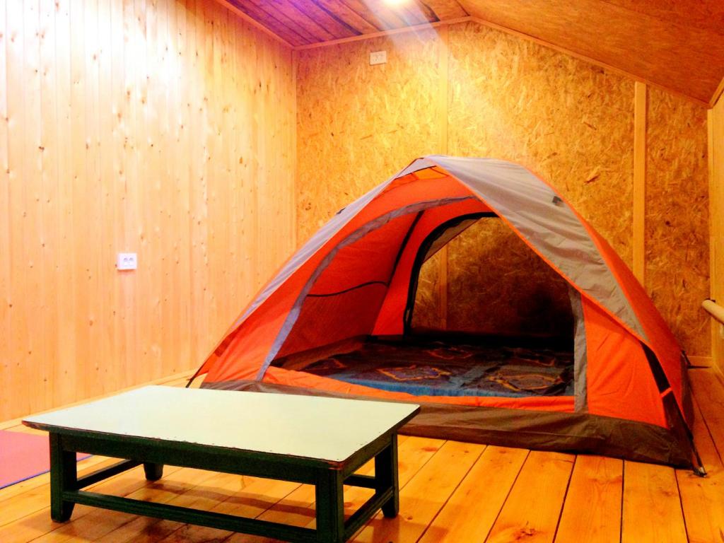 a tent with a table in a room at Urban Monkey Tent hostel & bar in Karakol