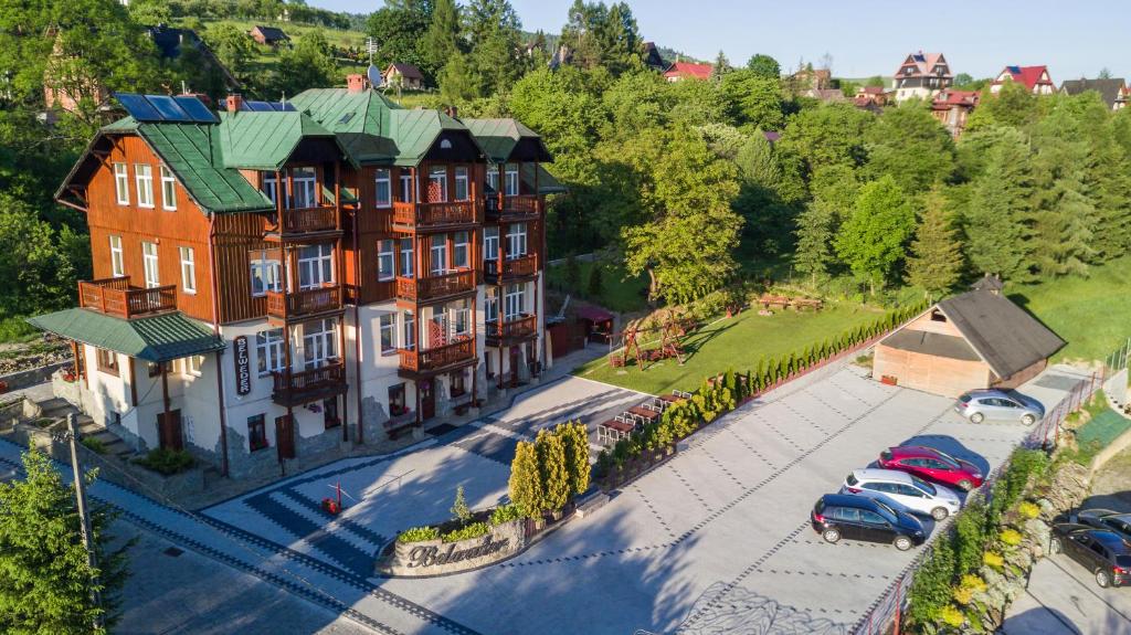 an aerial view of a large house with cars parked in a parking lot at Willa Belweder in Szczawnica