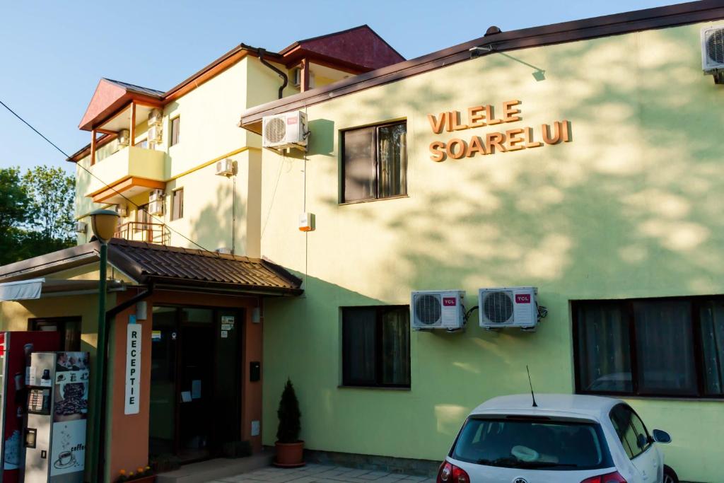 a car parked in front of a building at Vilele Soarelui in Neptun