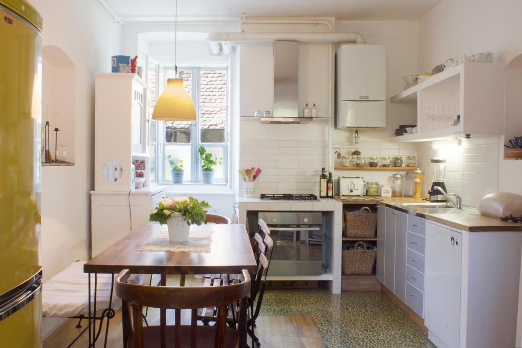 a kitchen with a wooden table and a dining room at House Dornik in Zagreb