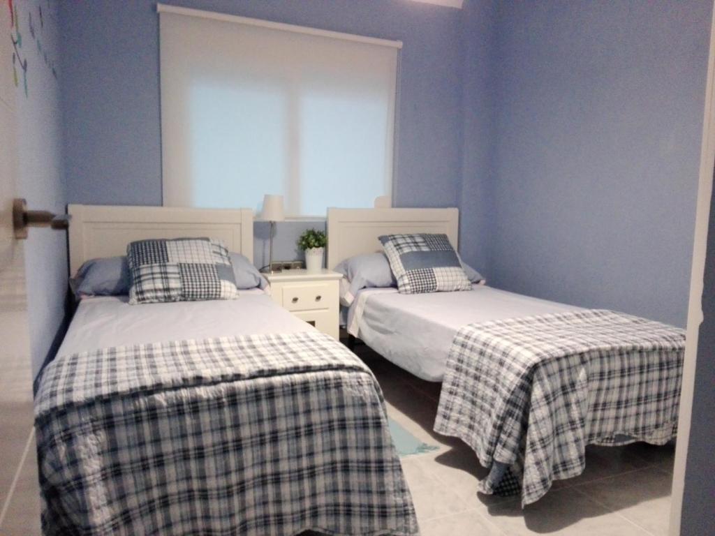Postel nebo postele na pokoji v ubytování Sweet Caroline Apartment