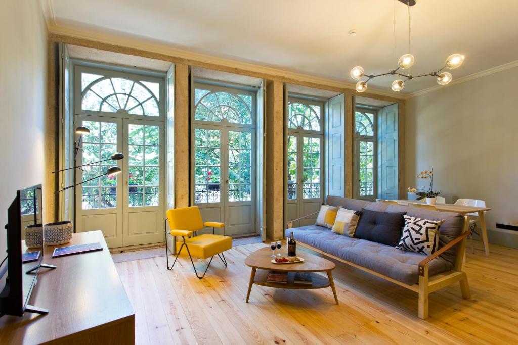 a living room with a couch and a table at Trait House in Porto