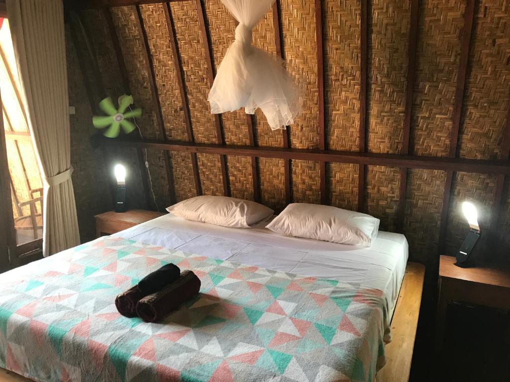 Postel nebo postele na pokoji v ubytování Meno Madia Bungalows