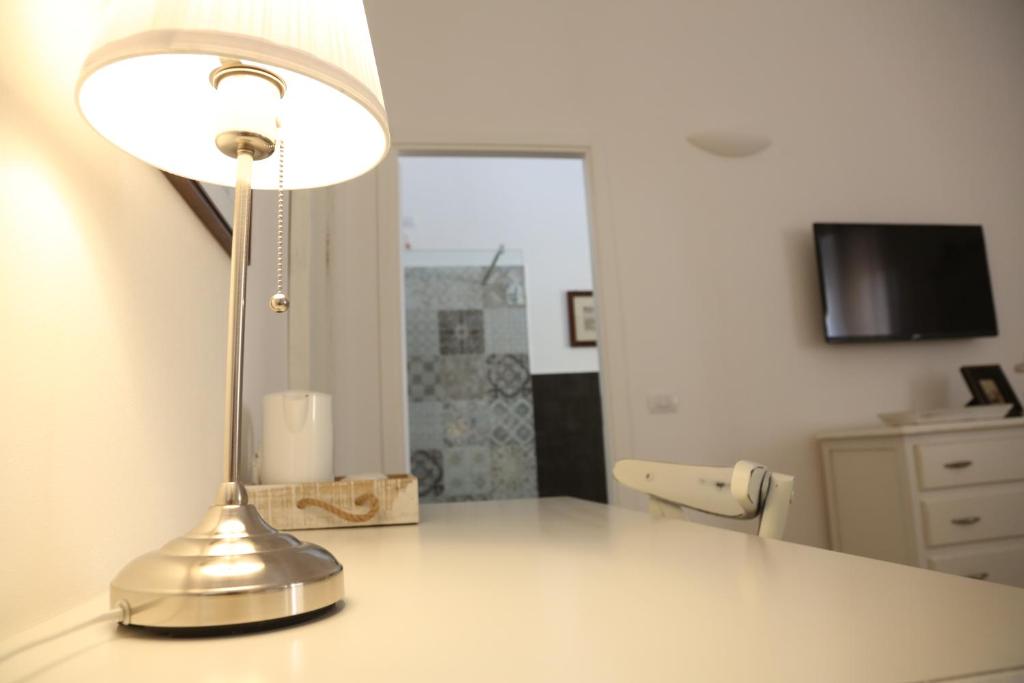 a silver lamp sitting on top of a desk at Dimi House in Lecce