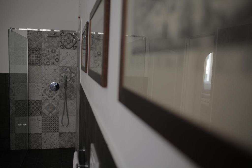 a bathroom with a shower with a mirror and a shower at Dimi House in Lecce