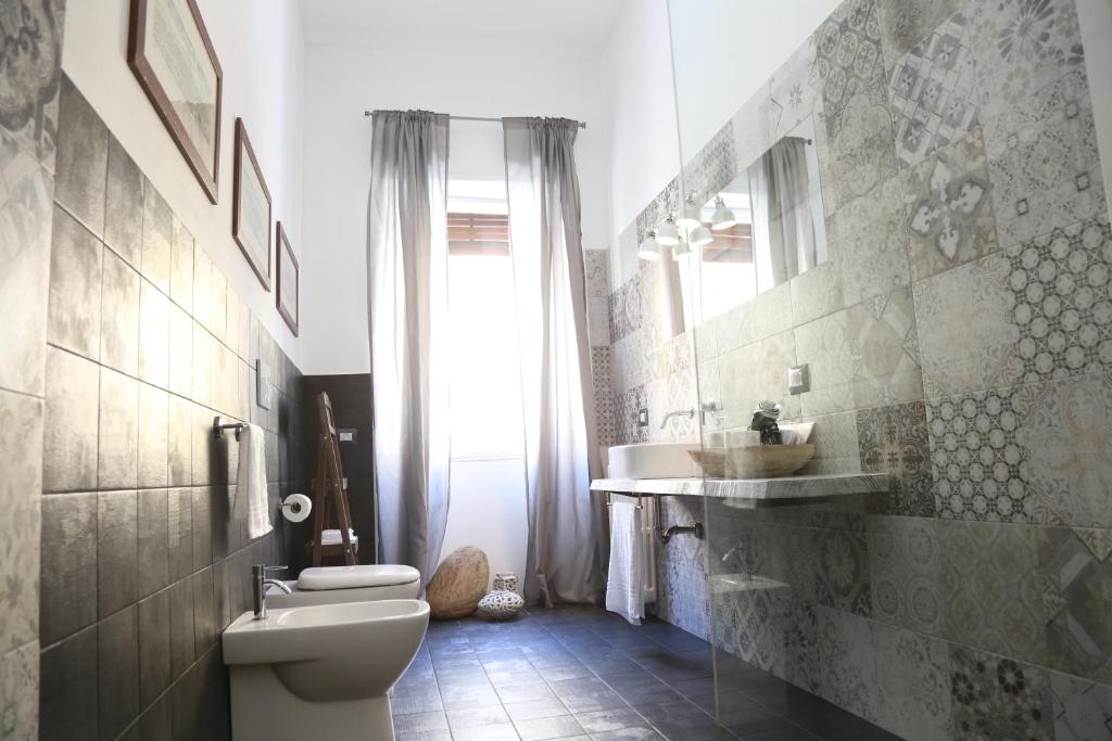 a bathroom with a toilet and a sink at Dimi House in Lecce