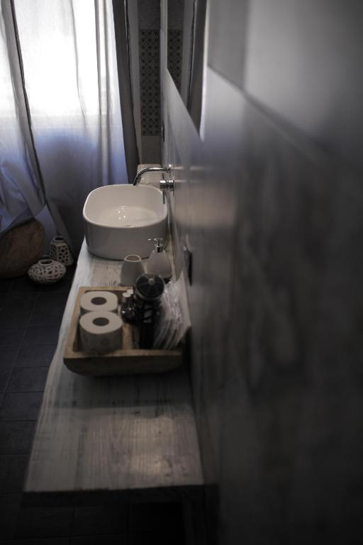 a bathroom with a sink and a plate with the number at Dimi House in Lecce