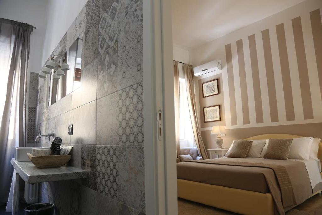 a bedroom with a bed and a sink in a room at Dimi House in Lecce