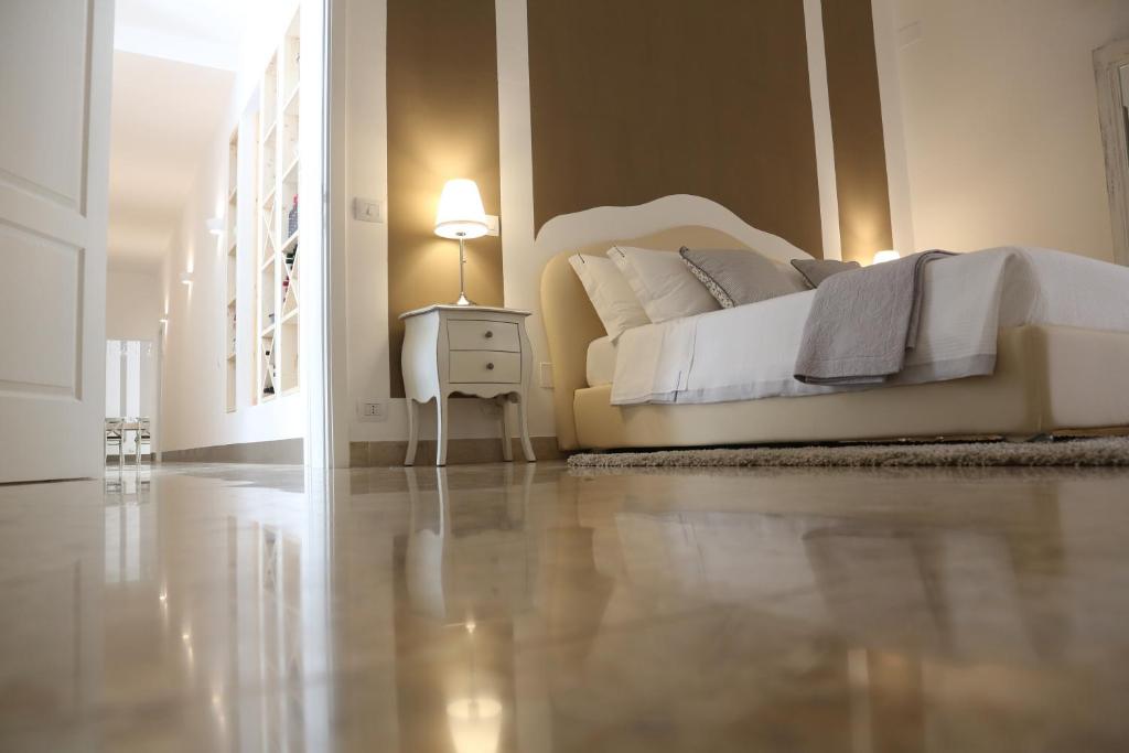 a bedroom with a bed and a night stand with a lamp at Dimi House in Lecce
