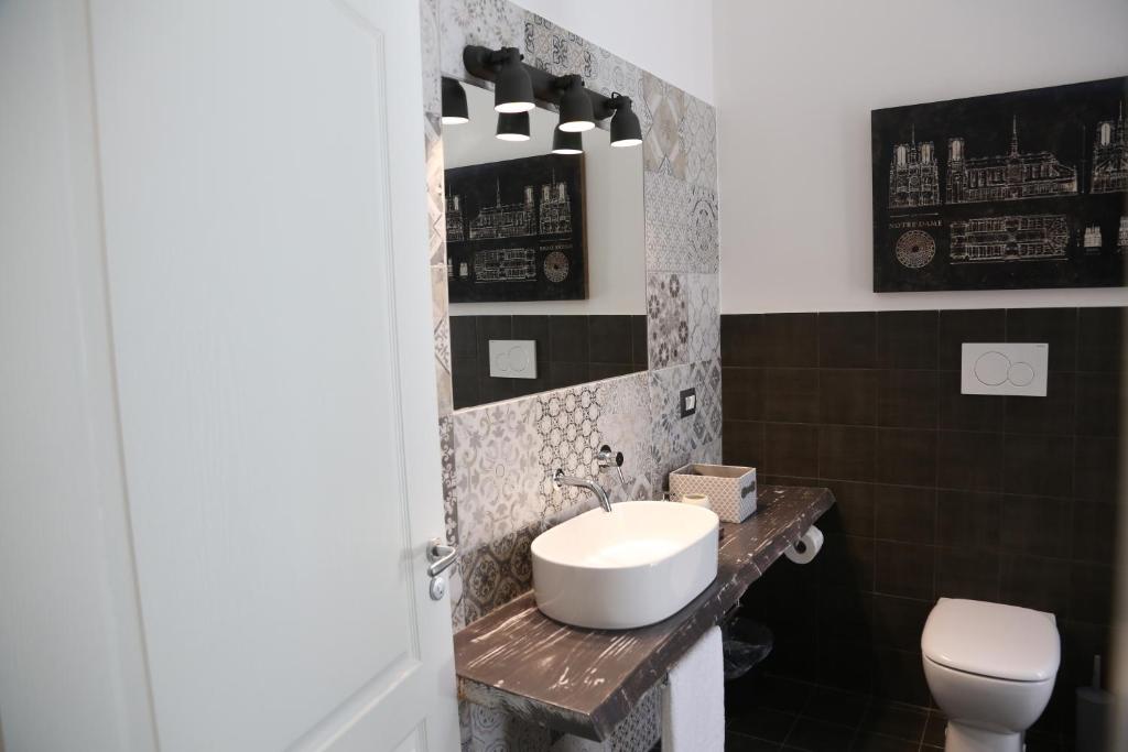 a bathroom with a sink and a toilet at Dimi House in Lecce
