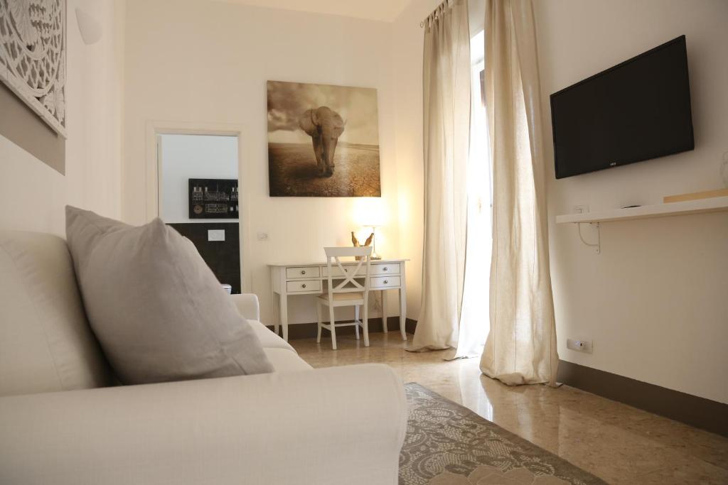 a living room with a couch and a table and a television at Dimi House in Lecce