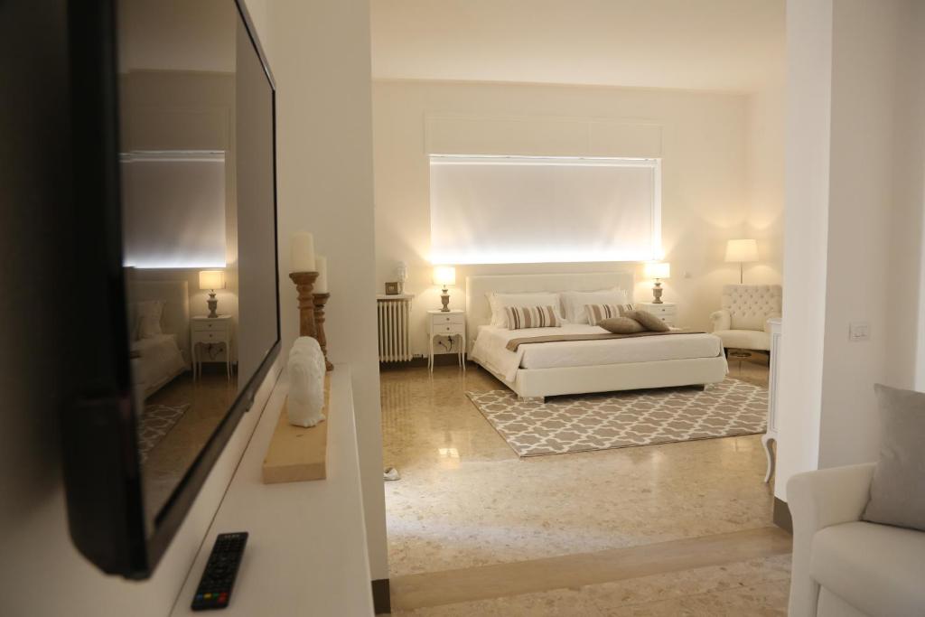 a white living room with a white couch in a room at Dimi House in Lecce