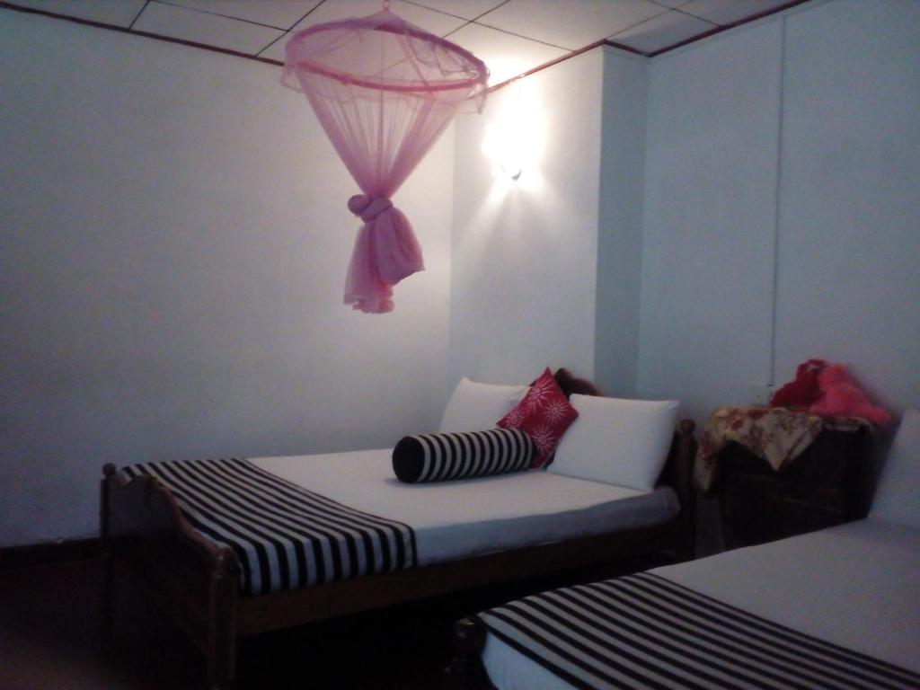 Postel nebo postele na pokoji v ubytování Forest Paddy Homestay