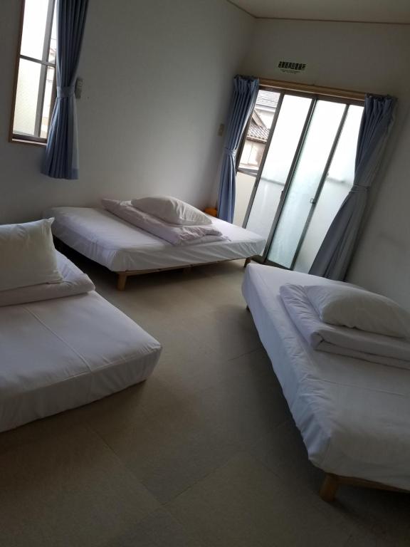Postel nebo postele na pokoji v ubytování Villa M Guesthouse