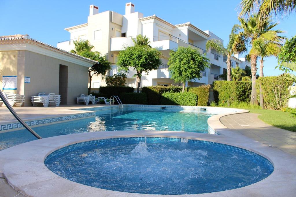 a swimming pool in front of a house at Âncora Boutique Apartments in Lagos