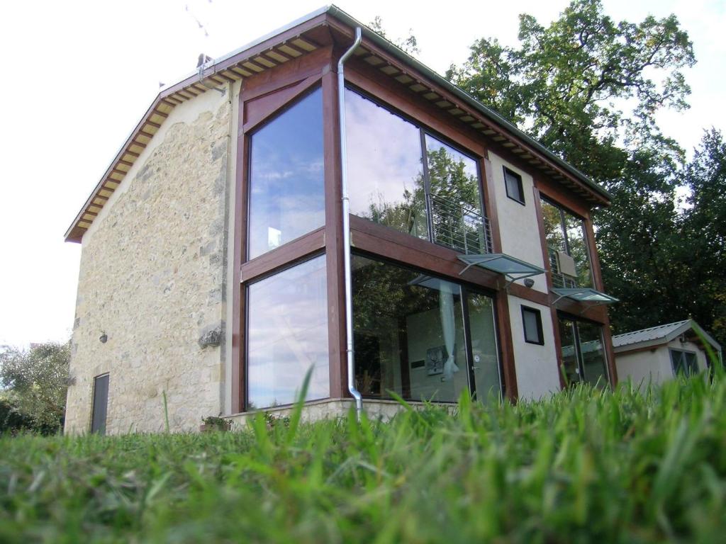 a house with large glass windows on the side of it at Masseria del Ponte in Pretoro