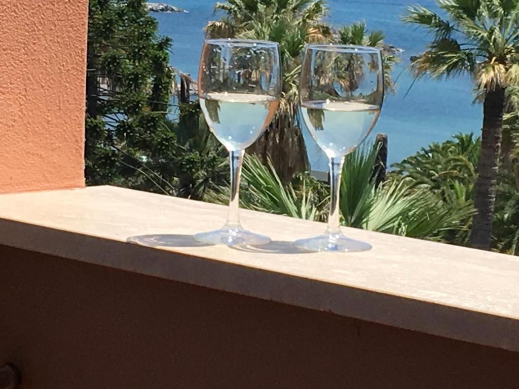 two glasses of white wine sitting on a ledge at Residence Imperiale in Sanremo