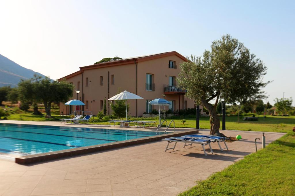 a swimming pool in front of a building at Case Mistretta in Altavilla Milicia