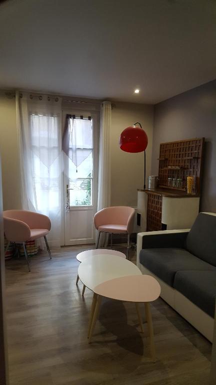 a living room with a couch and a table at Home St. Germain in Trouville-sur-Mer