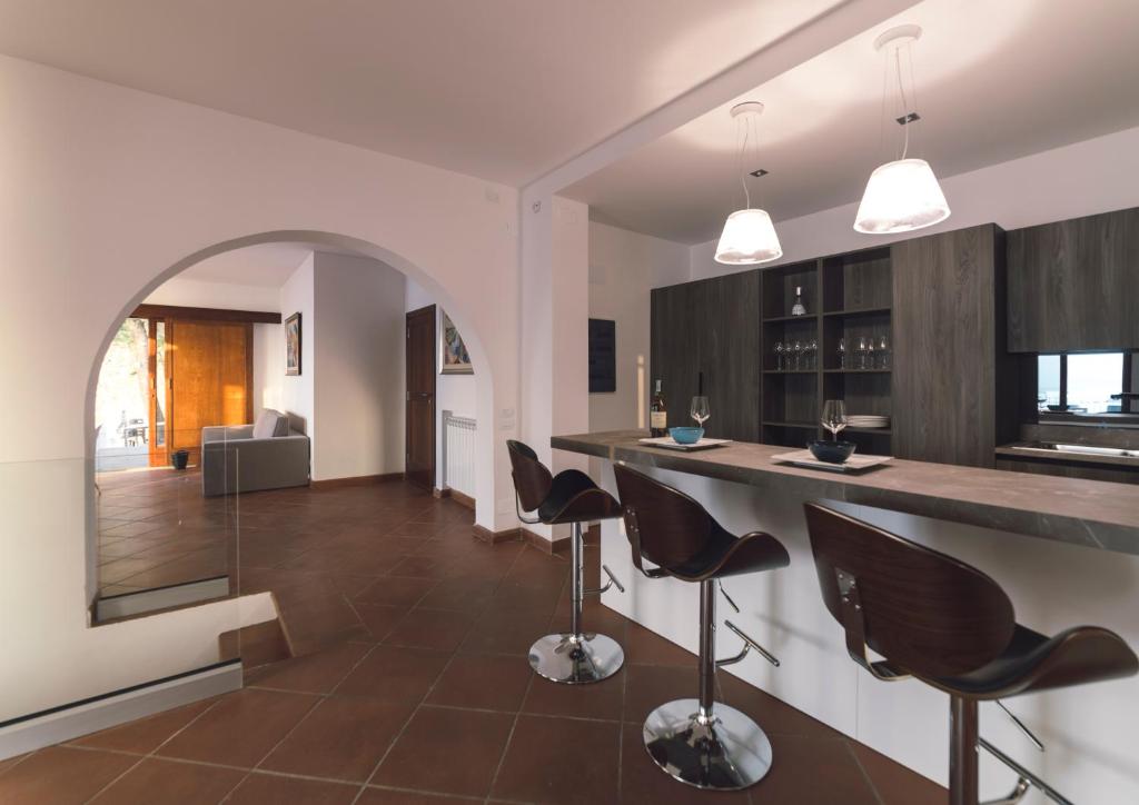 a kitchen with a counter and chairs in a room at Villa Crawford in San Nicola Arcella
