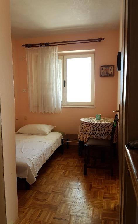 Postel nebo postele na pokoji v ubytování Apartments Brčić