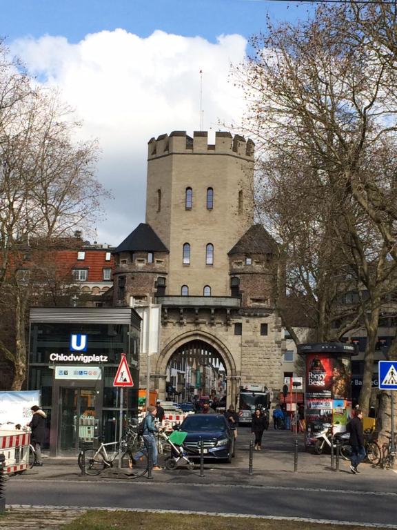 a building with a tower in the middle of a city at Köln City Apartments in Cologne