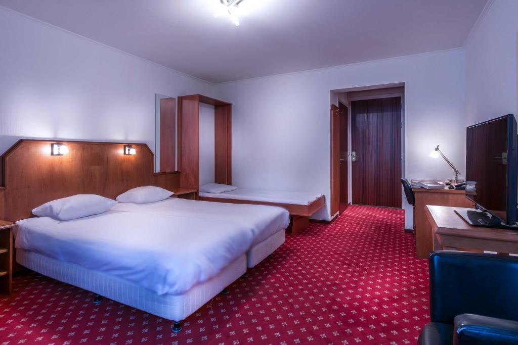 Postel nebo postele na pokoji v ubytování Hotel Riche