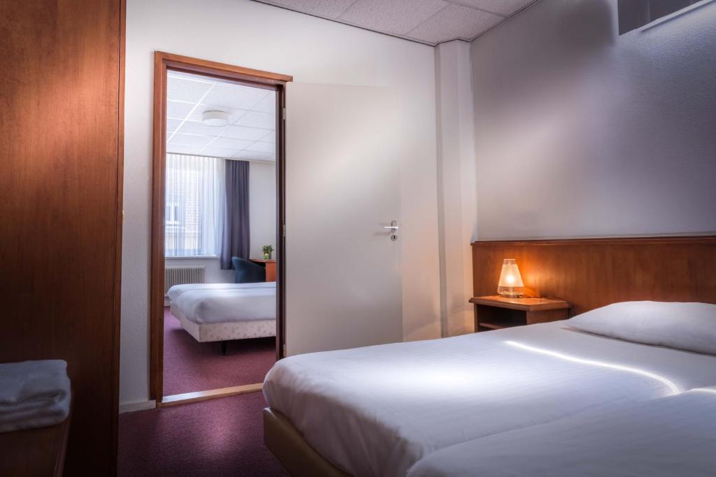 Postel nebo postele na pokoji v ubytování Hotel Riche