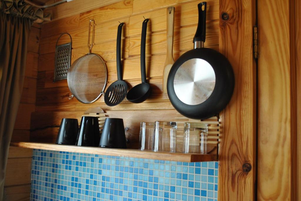 a kitchen with a mirror and utensils on a wall at Vacation Without Make Up in Šventoji