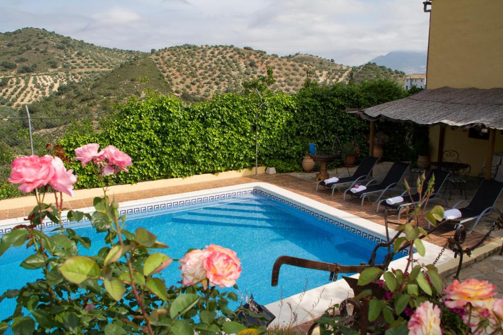 a swimming pool with a view of a mountain at Casa Rural Cortijos San Jose in Iznájar