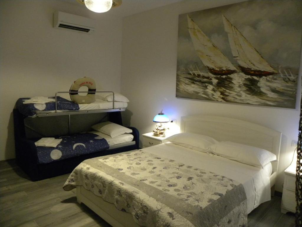 een slaapkamer met een bed en een bootschilderij aan de muur bij La Gemma delle 5 Terre in La Spezia